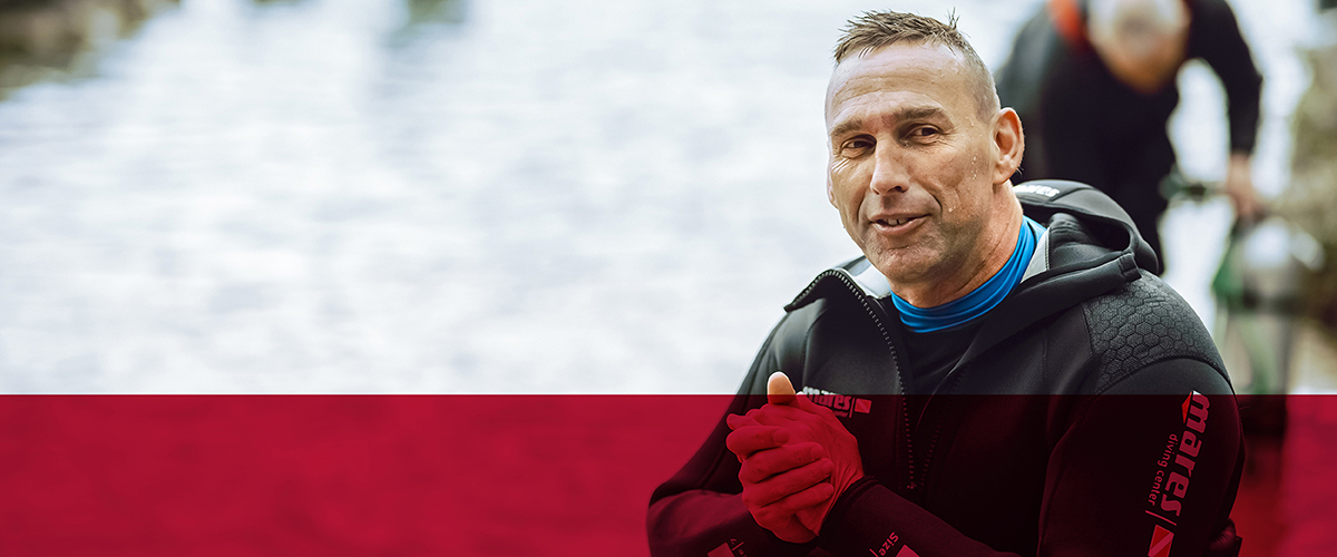 grinning-man-outdoors-rubbing-hands-together-sean